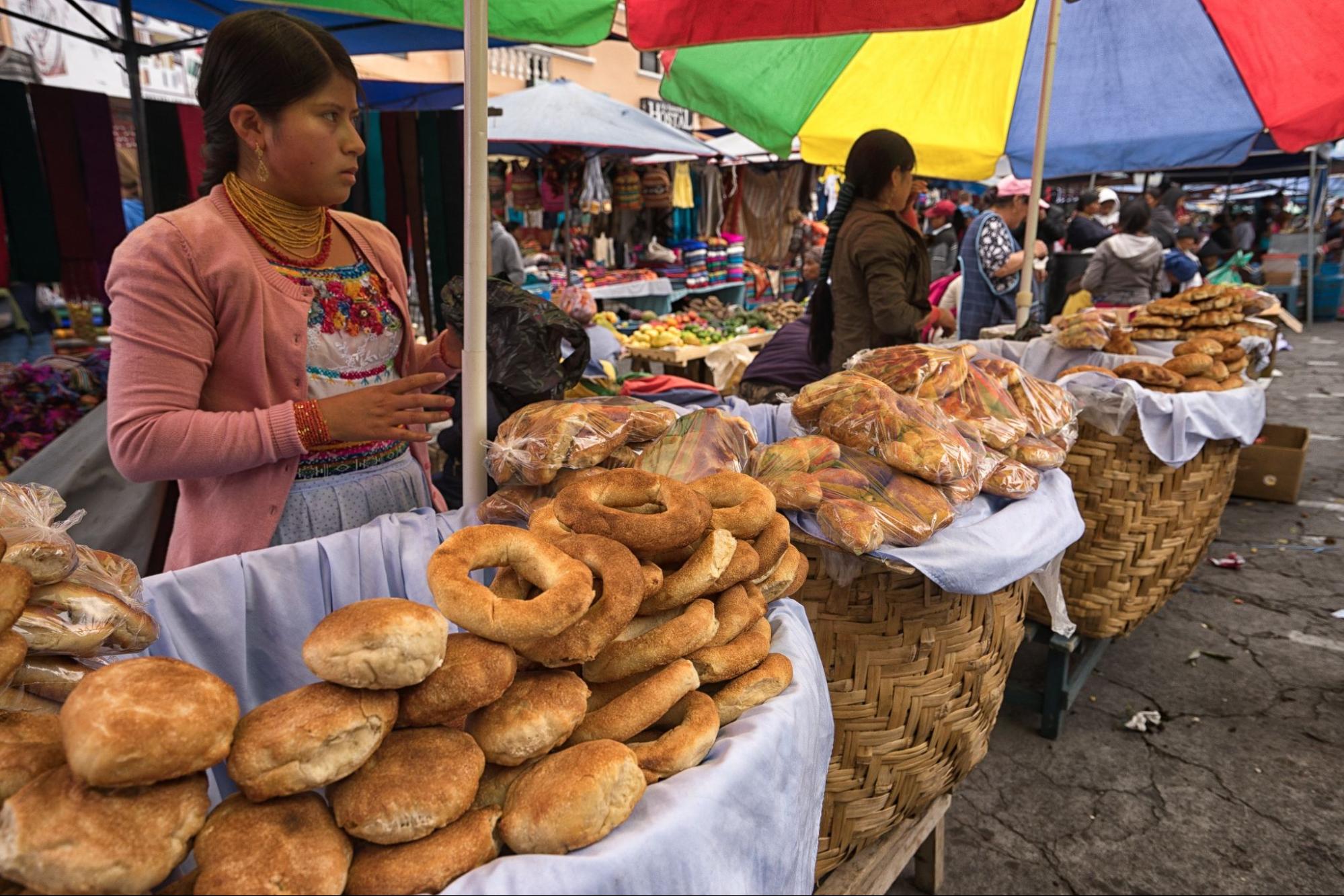 indigenous quechua women selling bakery products in the Saturday farmer's market